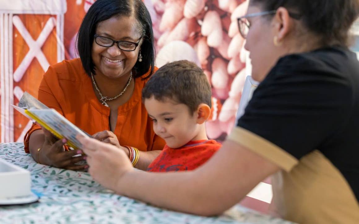 Two adults learning with child