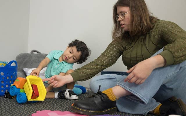 Teacher helping young child