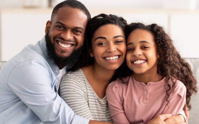 Dad, Mom and Daughter hugging