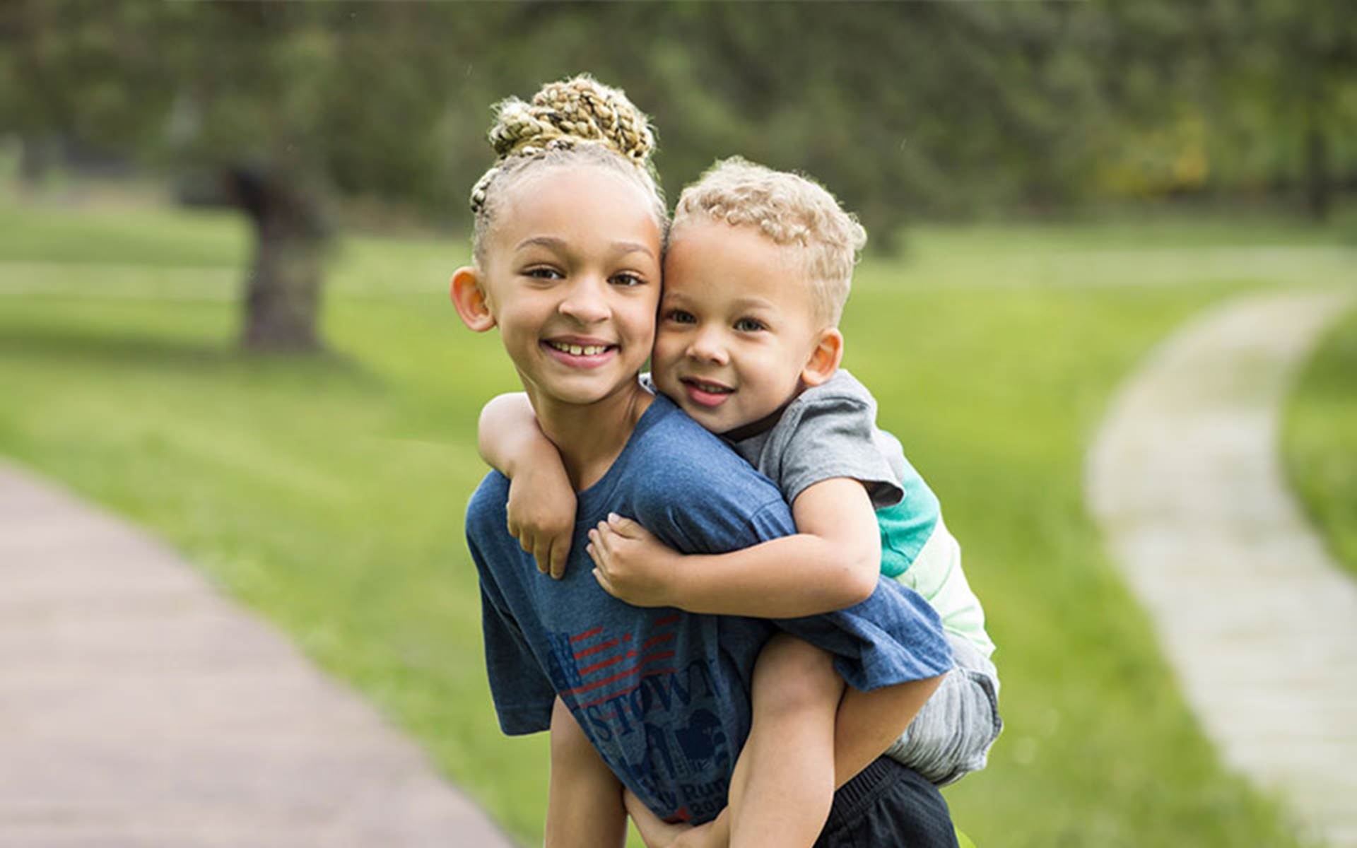 Girl carrying boy