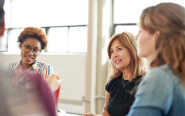 Adults discussing in a meeting room