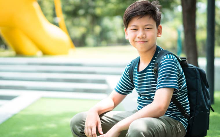 Student sitting at a park. 