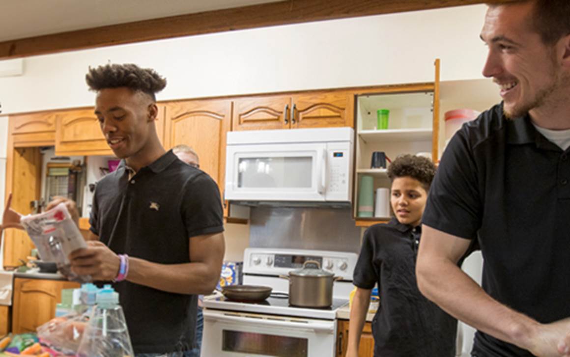 Family working together in kitchen