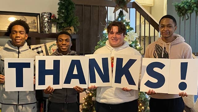 Boys Town kids holding Thanks sign