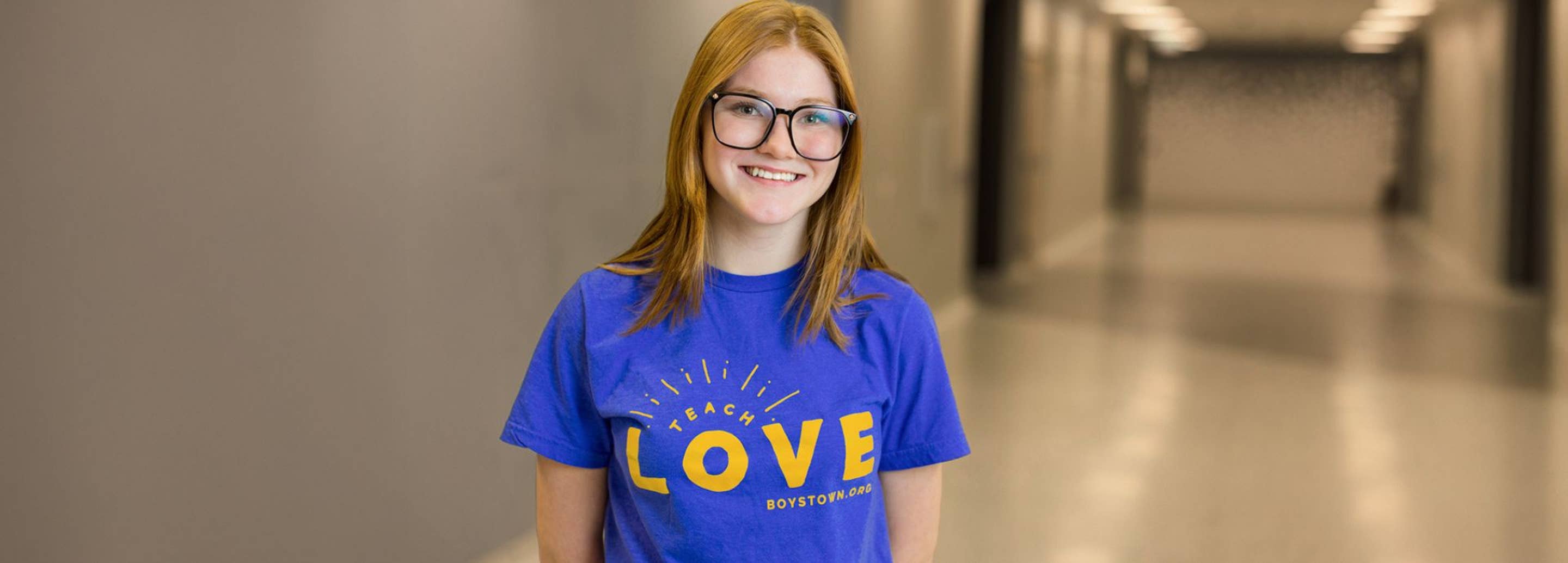 Girl wearing Teach Love T-Shirt
