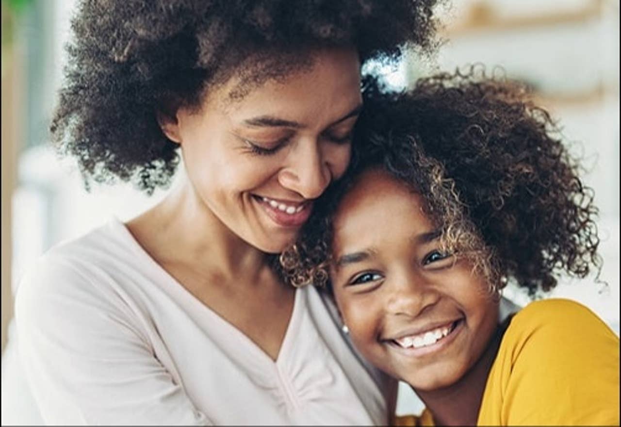 Mom hugging daughter
