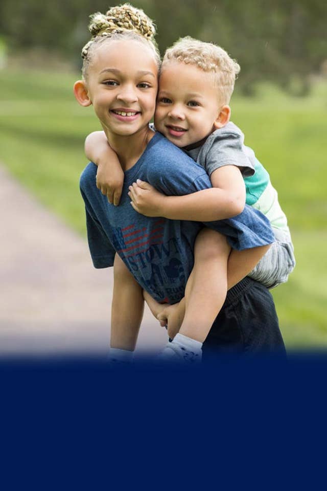Girl carrying boy hero banner