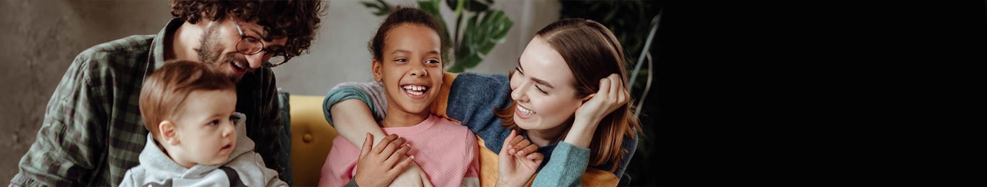 Foster family hanging out and smiling.