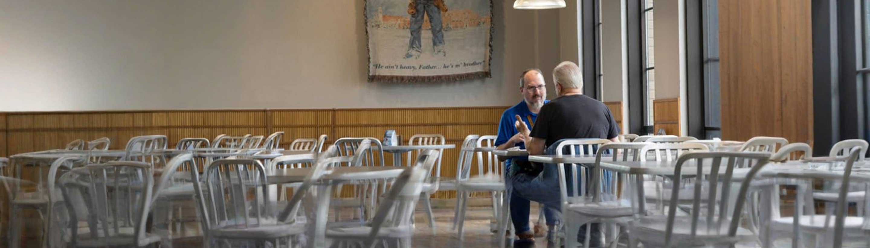 Two men eating lunch together