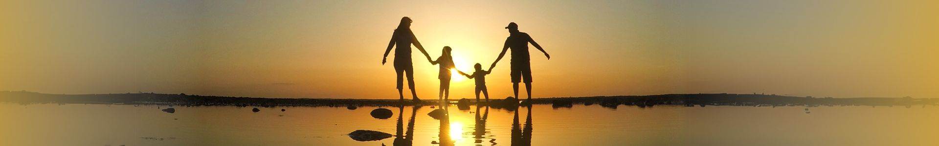 family walking on a beach