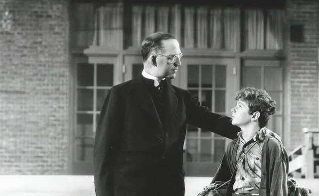 Father Flanagan consoling young boy
