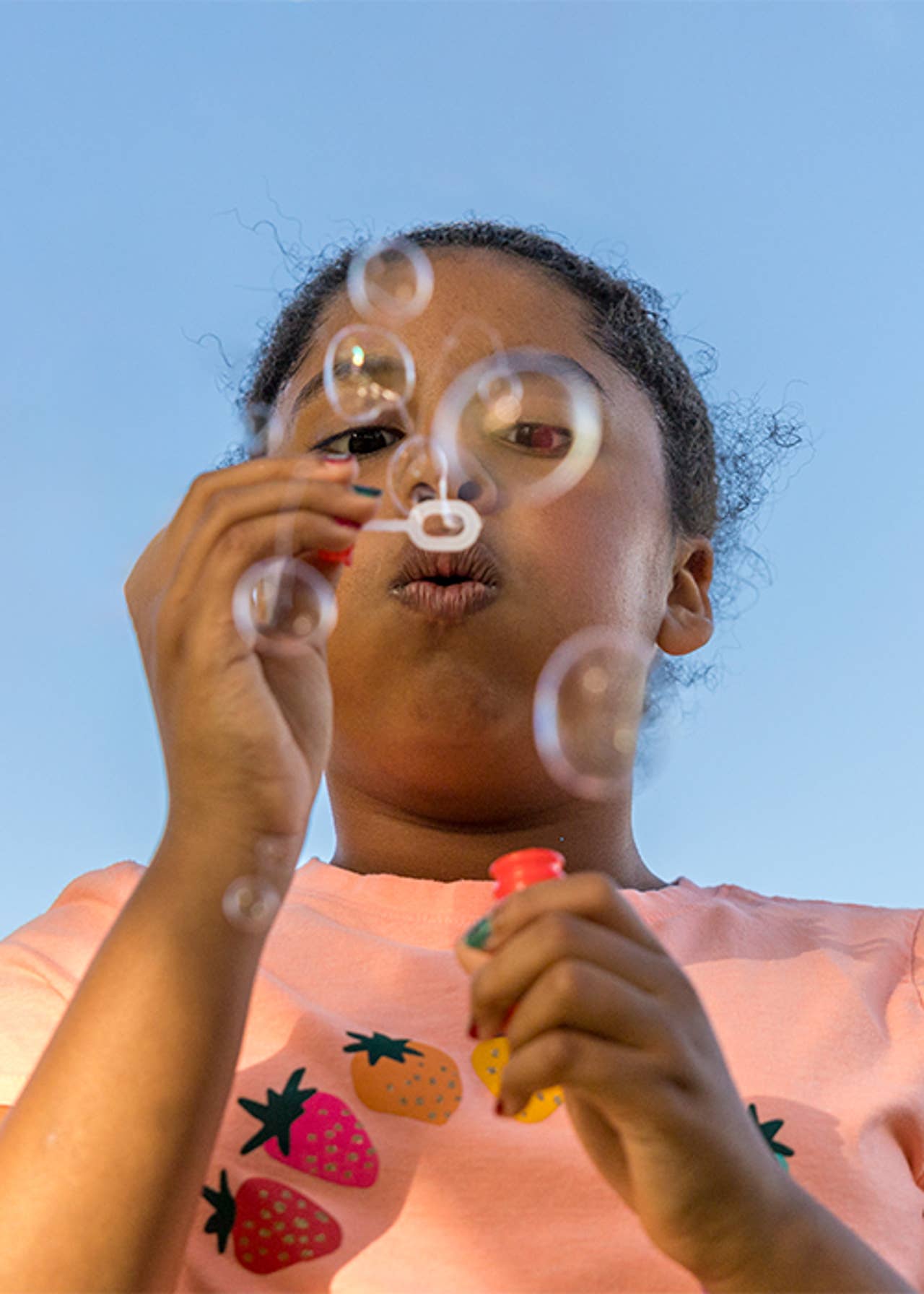 Girl blowing bubbles on a summer day