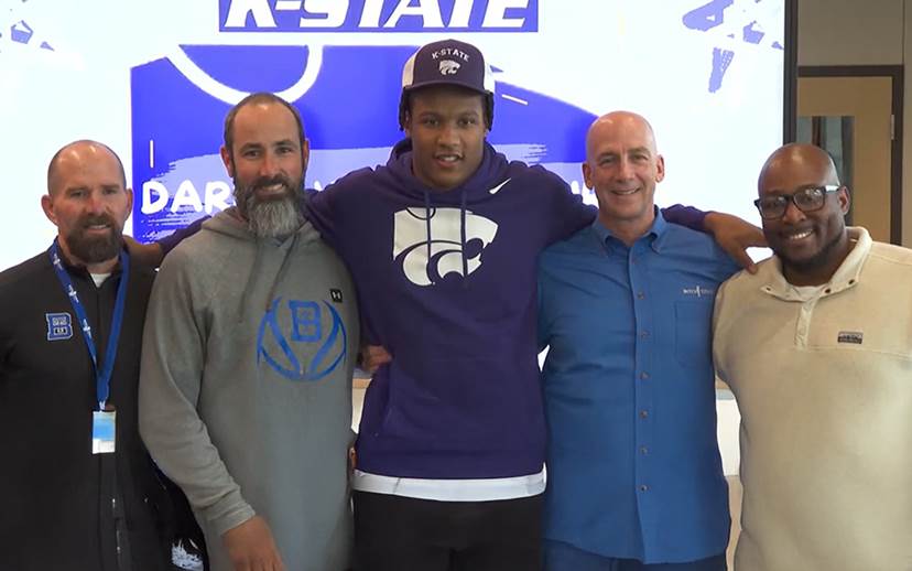 young man accepting a school scholarship to play football