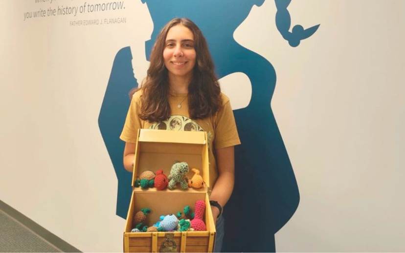 Kassandra  holding box of crochet projects for children