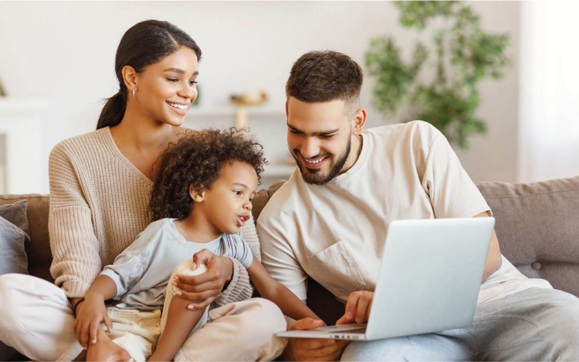 Mother, Father and Child looking at laptop