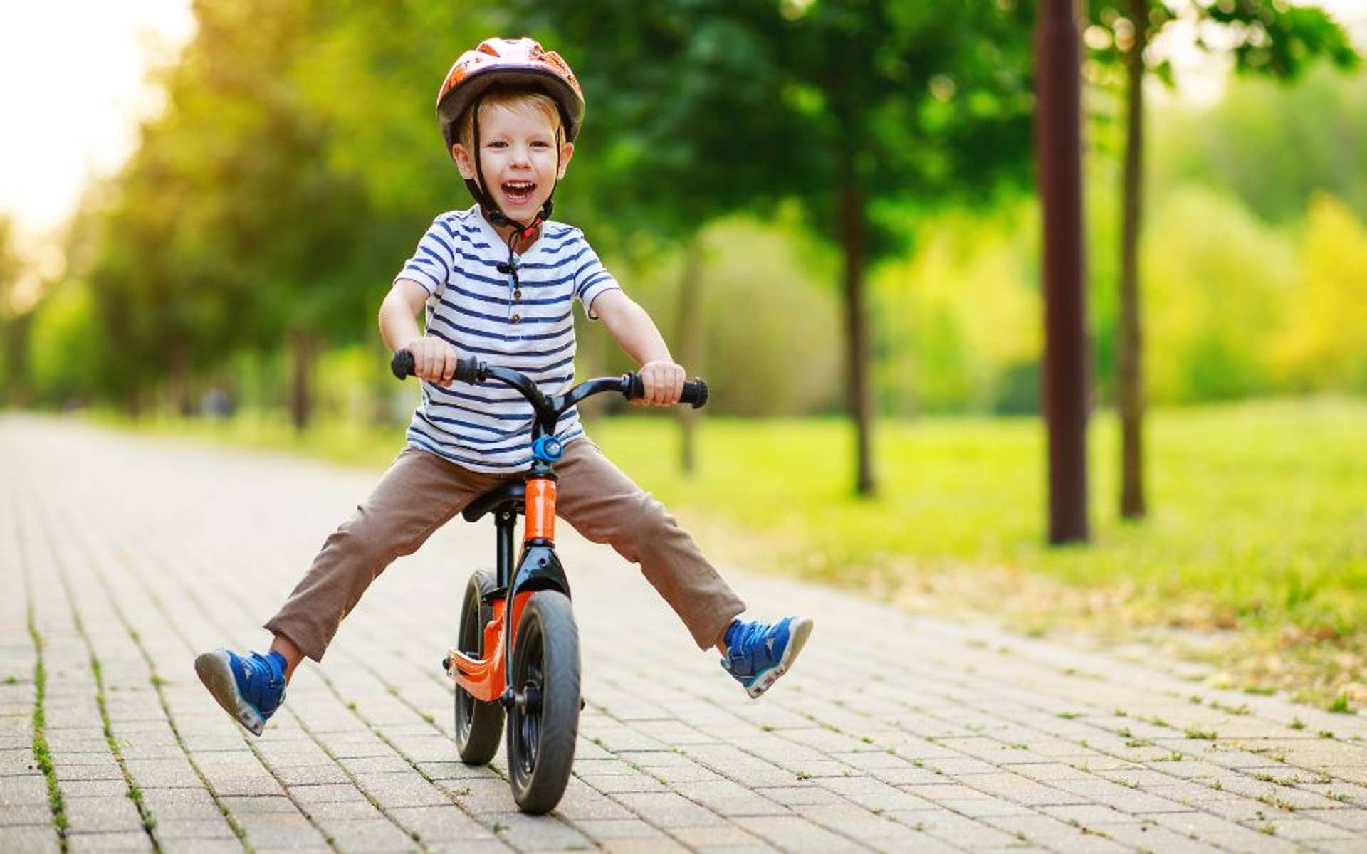 young boy riding bike outside