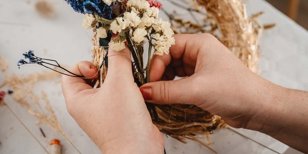 person making a wreath