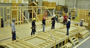 Guys working on a house together in construction