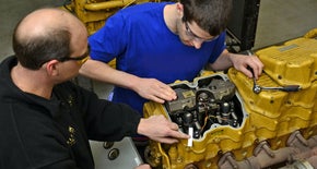 two guys working in a workshop