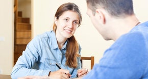 Two people working together with their books open