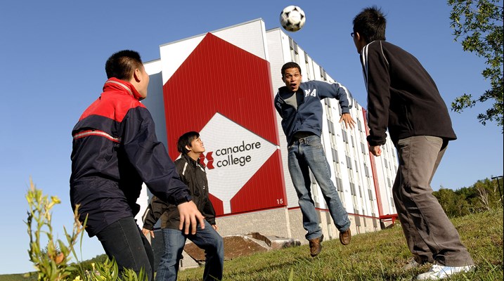 Students playing soccer outside of residence