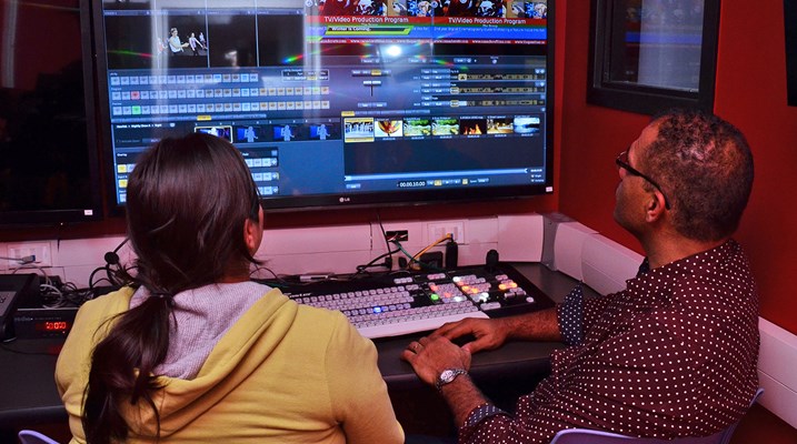 Student and teacher working in an editing suite