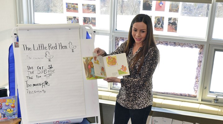 Young woman reading a story to children