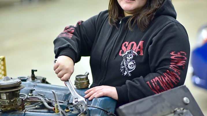 Indigenous woman working on an engine