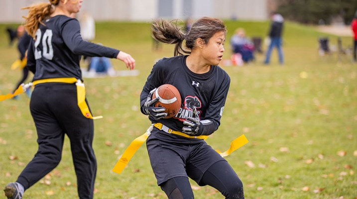 Woman holding football