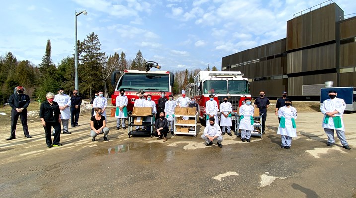 Students posting with firefighters