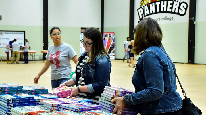 People picking up children's books