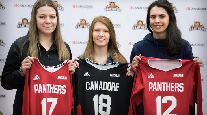 The girls holding jerseys