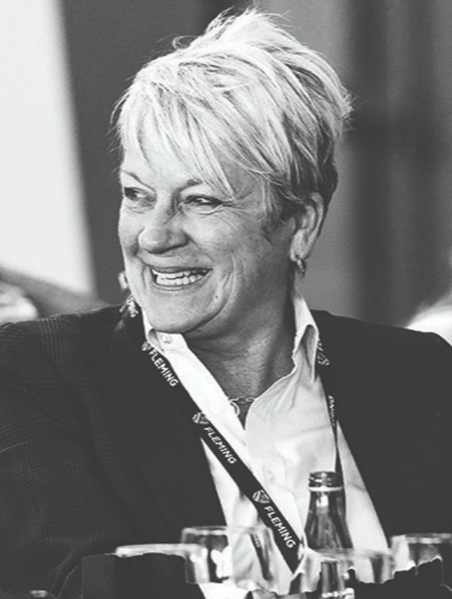 Black and white photograph of College's Ontario President and CEO, Maureen Adamson. She is pictured laughing, smiling and with her head turned to the side,