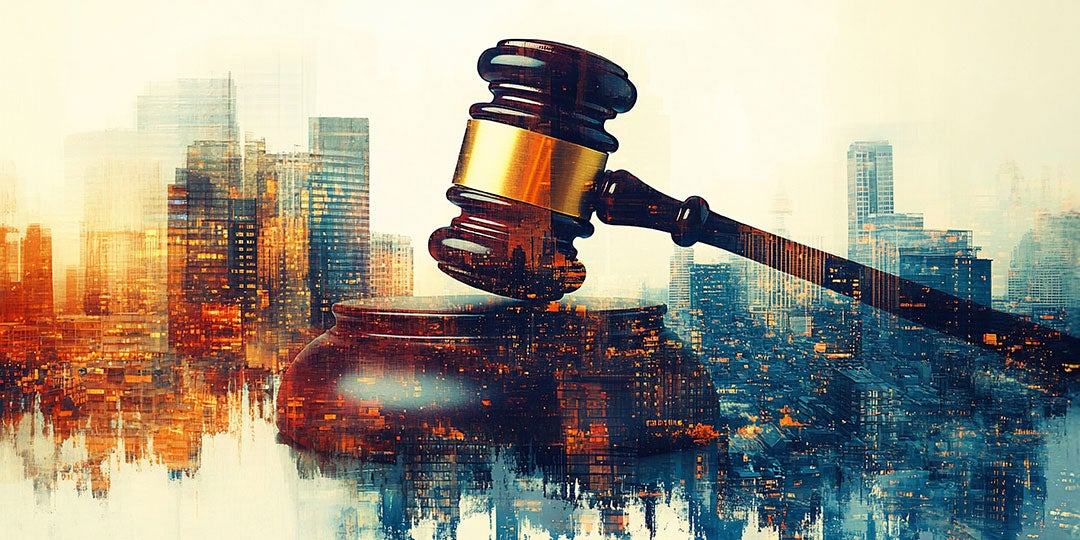 A judge's gavel in front of a city skyline