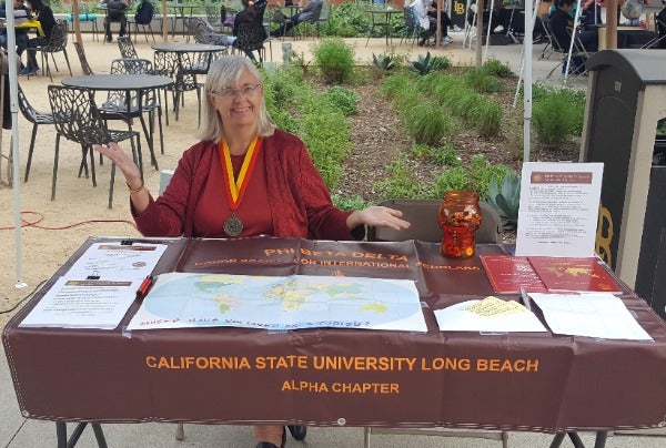 Lesley Farmer promoting Phi Beta Delta at International Education Week in November 2019