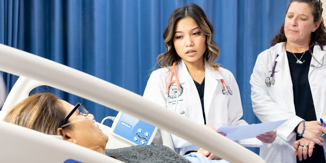 A nurse in a white coat attending to a patient in a clinical setting