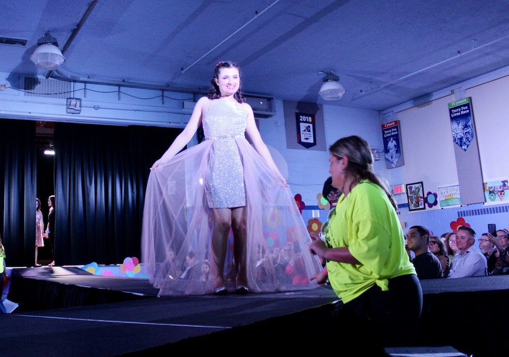 Student Ionna Saviolidis models a dress from Le Château down the catwalk at the “Welcome to the 60s” fashion show at Summit School on April 25. 