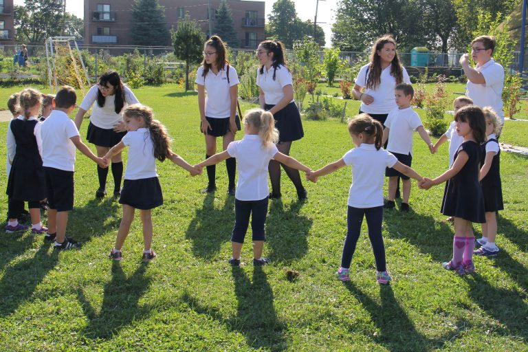 Students in BASE playing outside on the grass