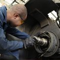 auto mechanic fixing wheel