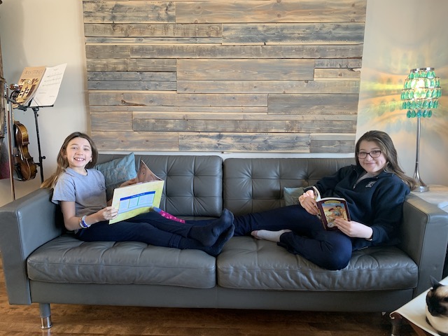 two girls holding books