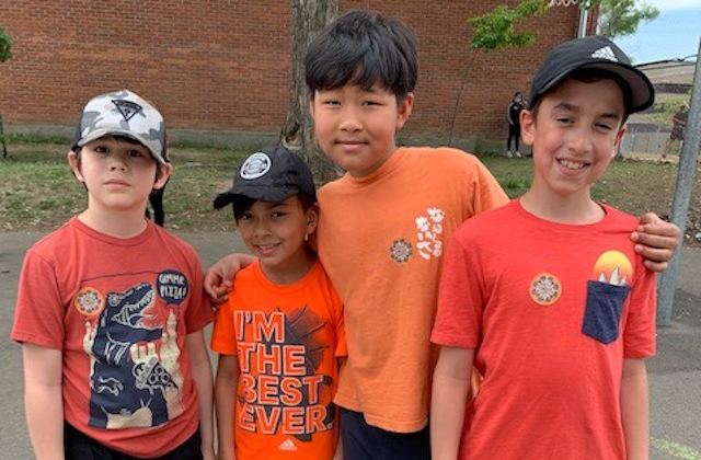 four kids wearing orange t-shirt