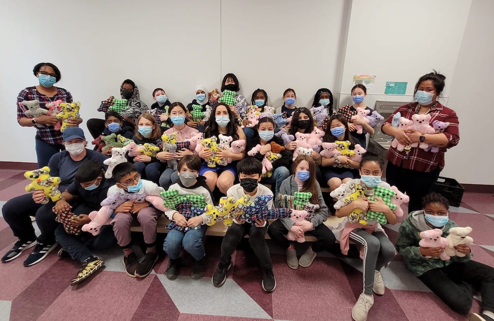 students holding dolls