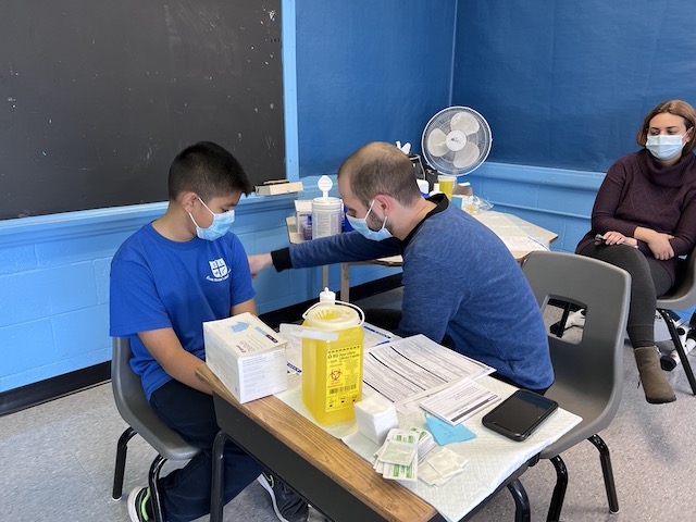 student getting vaccined