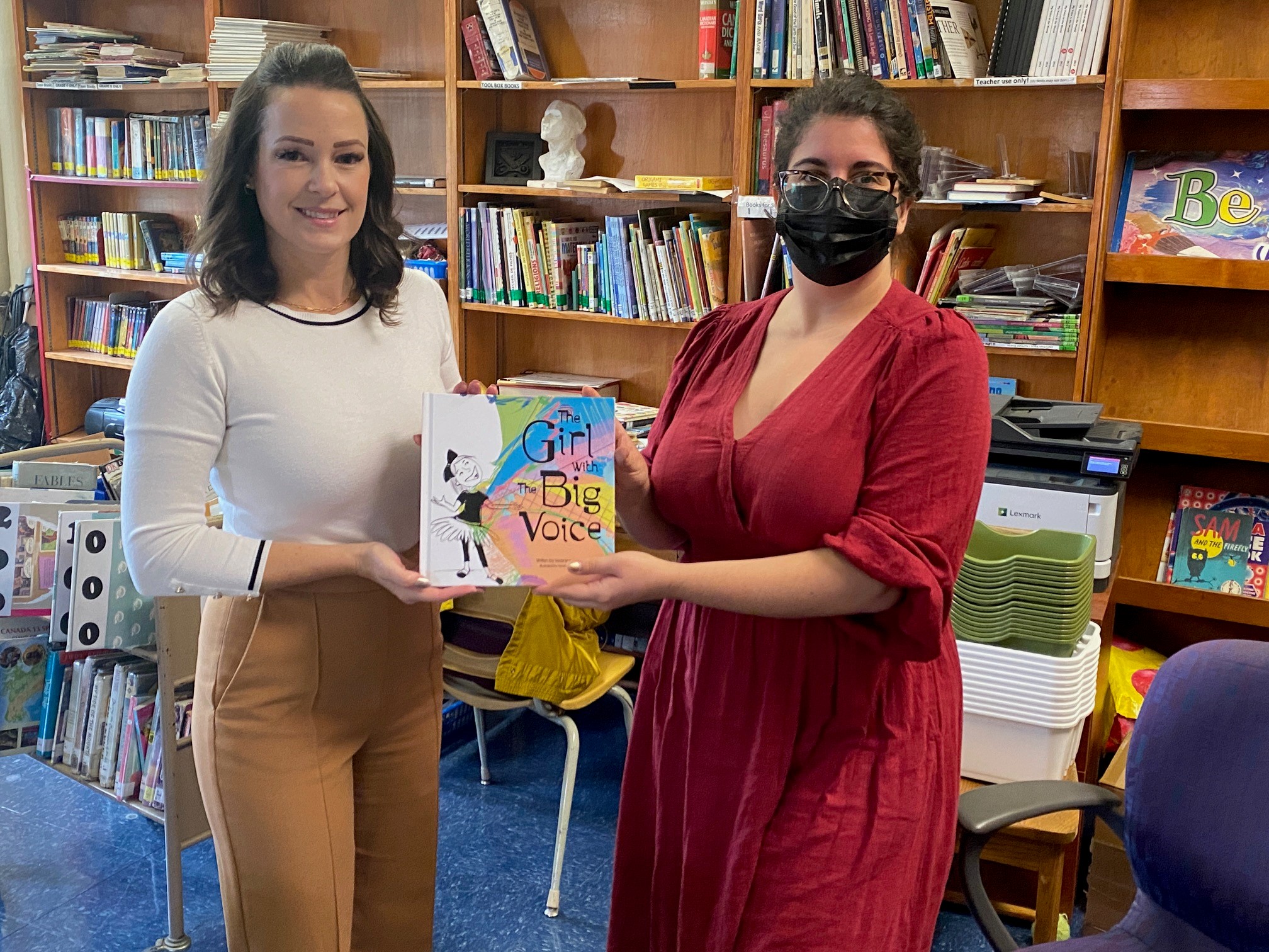 2 people holding the book