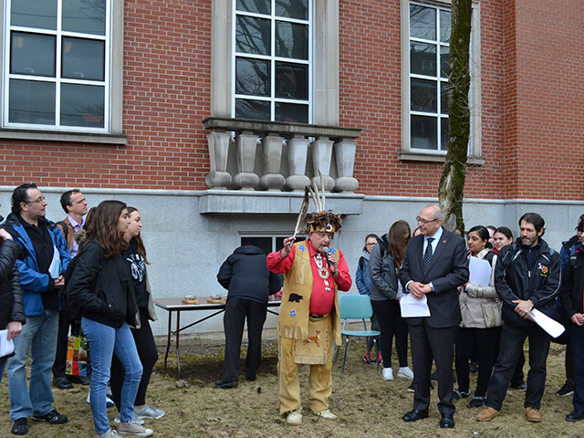 first nation elder man speaking with students