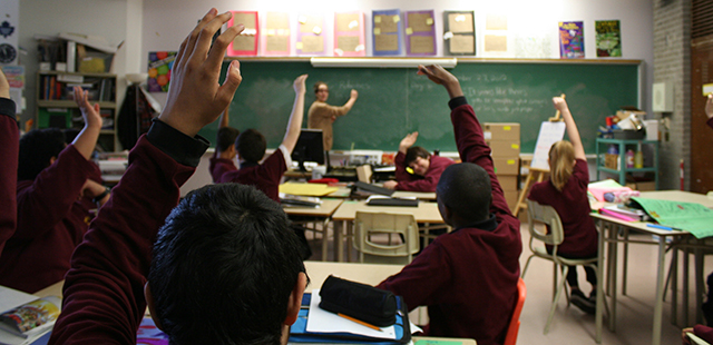 highschool-classroom-hands-up.