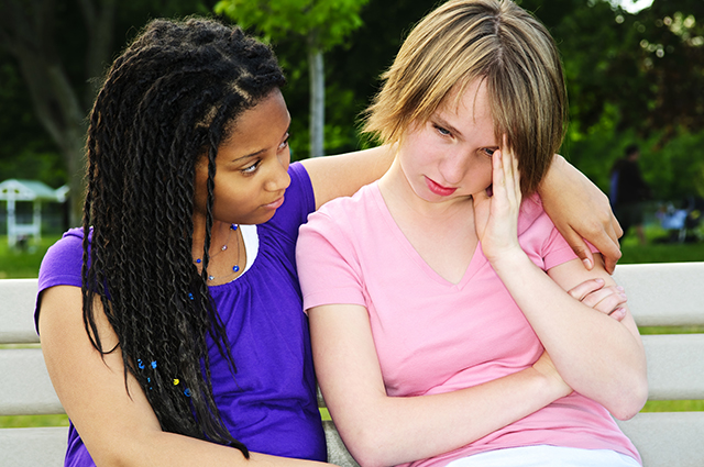 sad-teen-girl-comforting-friend