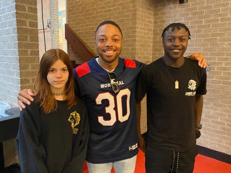 Chandler Worthy (middle) chats with James Lyng High School Secondary II students, Regan Vitale, left, and Daren Willson Taku Mbame on October 4. Photo: Mike Cohen 