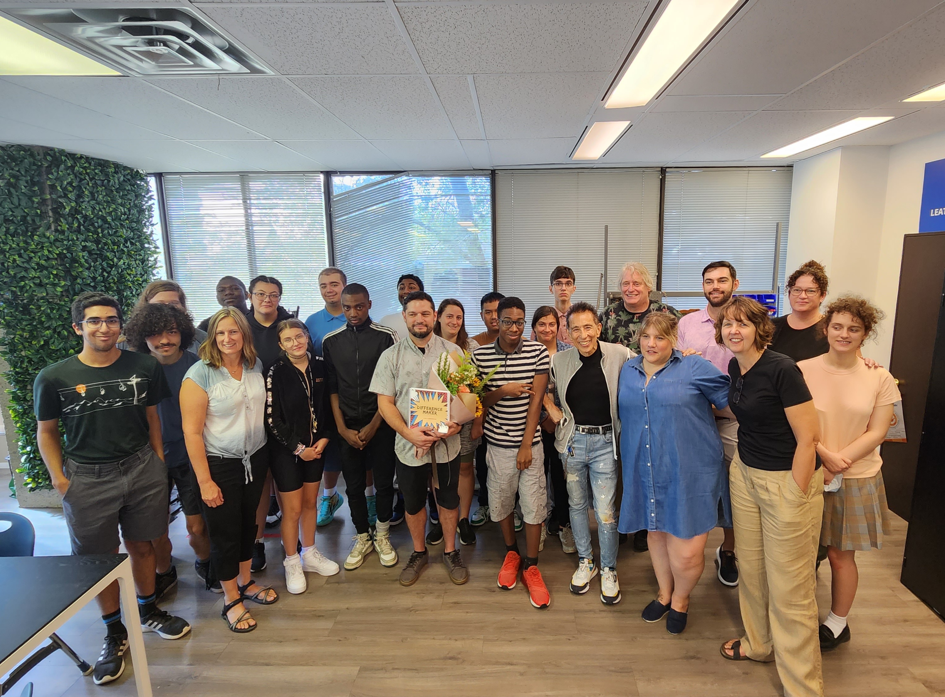 Simon Chang announces Josh Cunningham’s award at Summit TECC, surrounded by students and staff on September 7. Photo: Liam Boucher