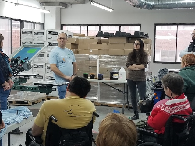 Promo 21 founder Martin Gould demonstrates the fine art of silk screening to members of Action Centre on December 6.